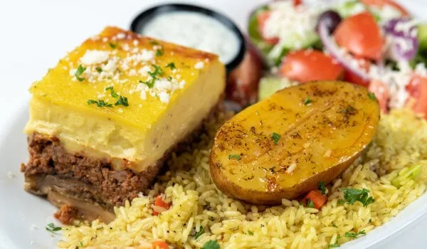 Greek moussaka with rice, potato, and salad